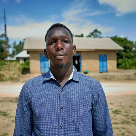 a man is stood outside, facing the camera.