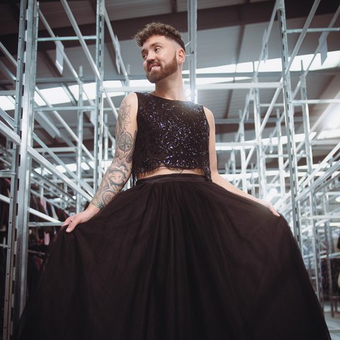 Conor 'The boy in the dress' at the oxfam warehouse at Milton point, wearing a sparkly black top, and a large maxi black tulle skirt