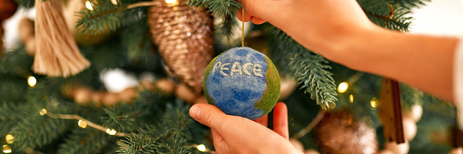 A felt decoration of the Earth with Peace written on it