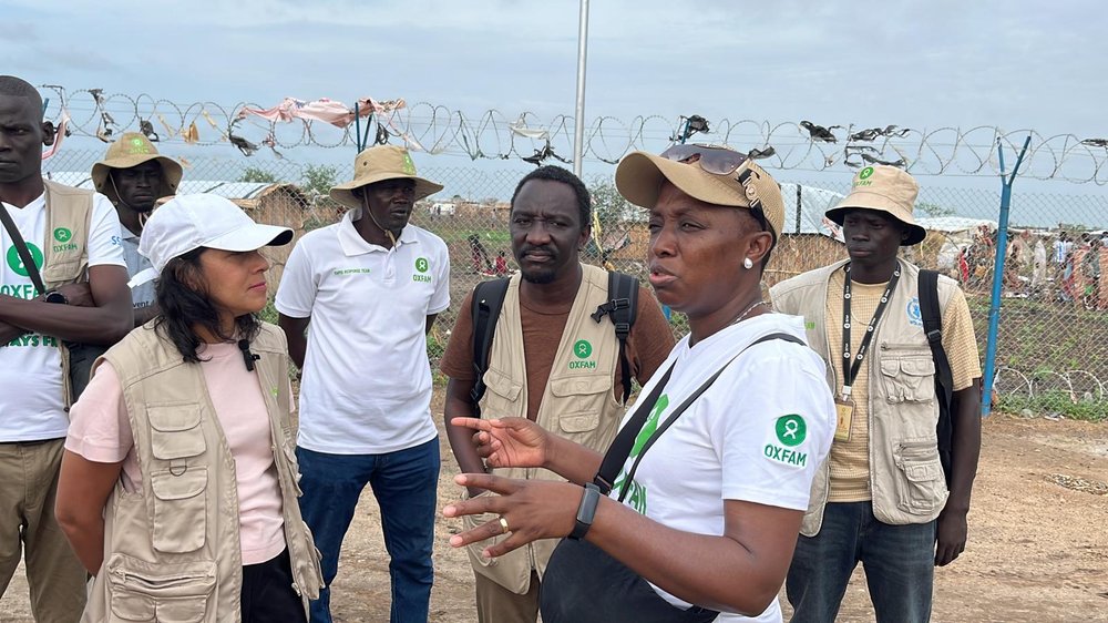 Halima Begum in Sudan talking with Oxfam partners