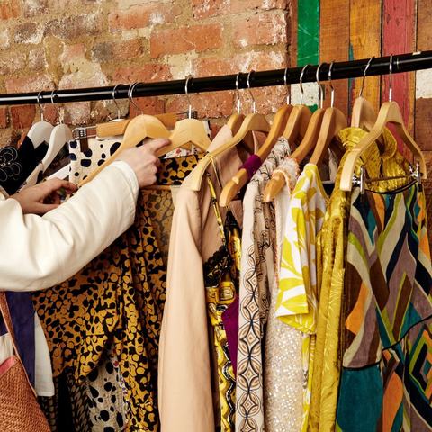 Person looking at clothes on a clothes rail