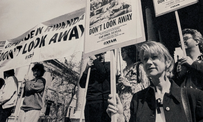 Protestors holding signs reading "Genocide in Rwanda - Don't look away"