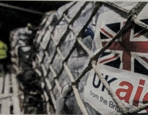 A shipment of aid being loaded with a label reading "UK aid"
