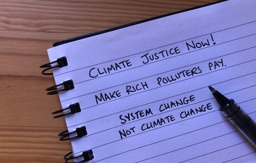 Pad of paper with ideas for placard slogans written on.