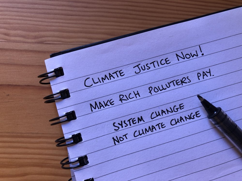 Pad of paper with ideas for placard slogans written on.