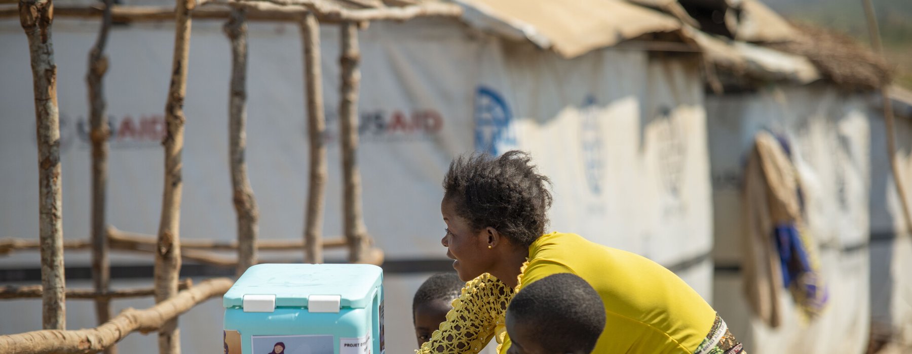 Lumbumba shows her young children how to use the new hand washing kit