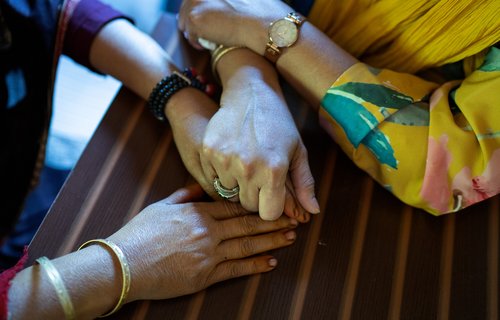 Women's hands holding each other
