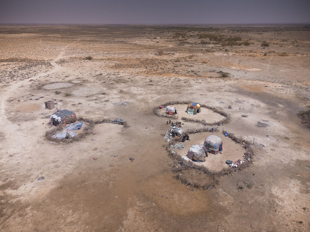 Some tent structures in the desert from above.