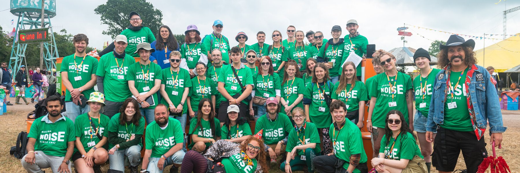 Oxfam campaigners pose for a group photo at Glastonbury Festival 2022