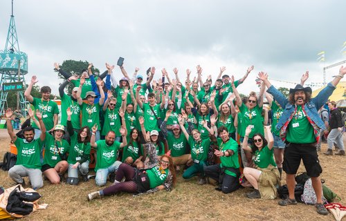 Group of Oxfam campaigners cheering at Glastonbury festival