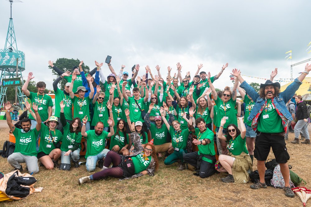 Group of Oxfam campaigners cheering at Glastonbury festival