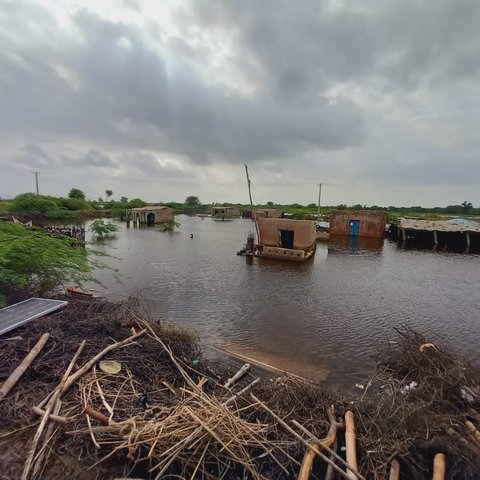 Some empty concrete buildings with flood water all around.