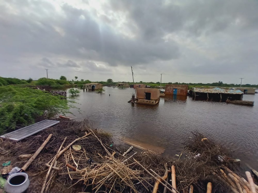 Some empty concrete buildings with flood water all around.