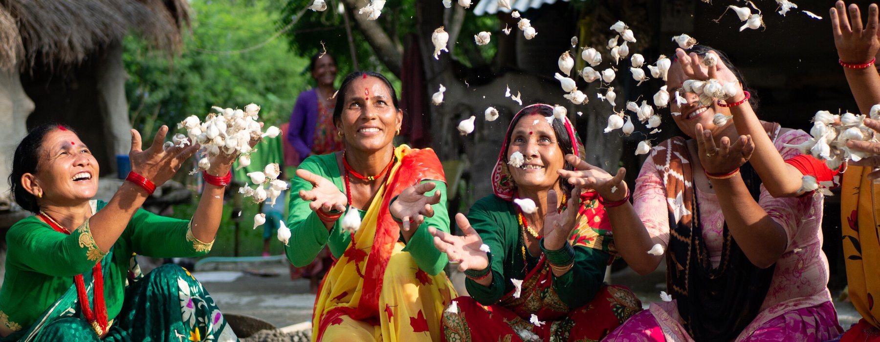 Members of a women’s group celebrate the success of their garlic project.