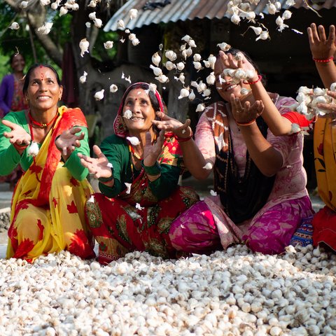 Members of a women’s group celebrate the success of their garlic project.