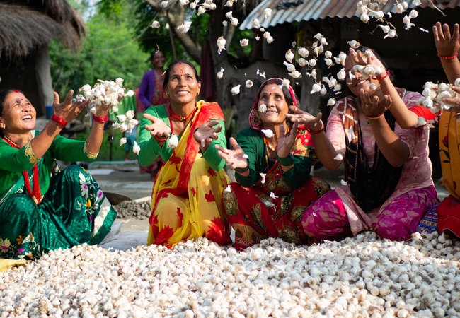 Members of a women’s group celebrate the success of their garlic project.