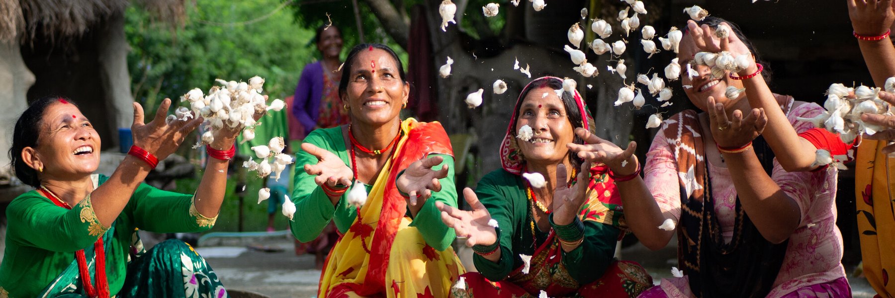 Members of a women’s group celebrate the success of their garlic project.