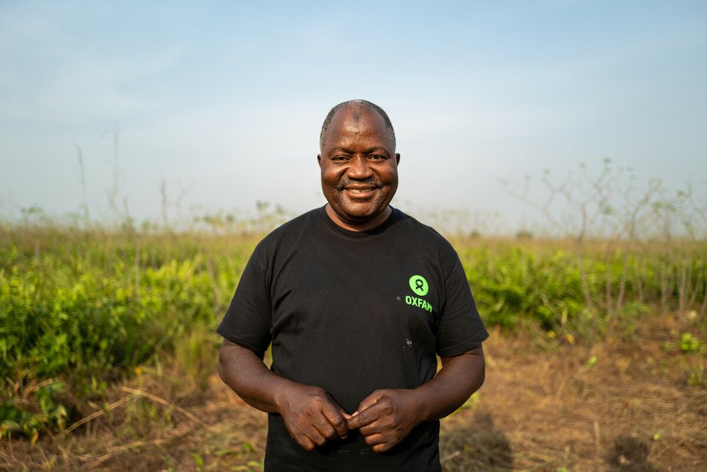 Alpha Sesay, Legacy Program Manager, Oxfam in Sierra Leone stands off the 14 acre cassava farm run by FEMINET in Port Loko, Sierra Leone.