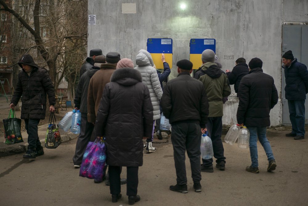 A group of people collecting water from Oxfam water points