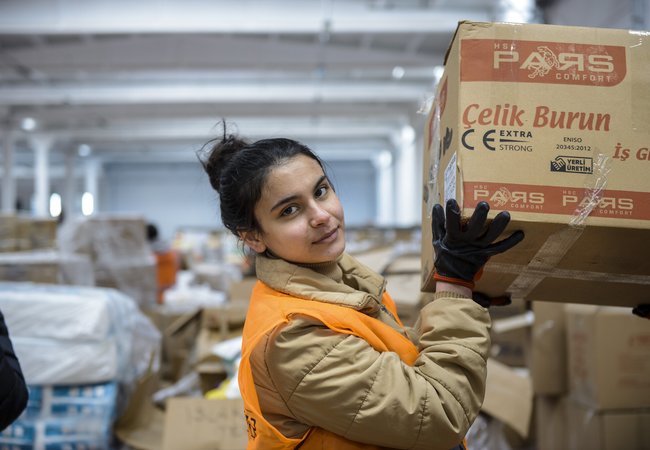 A young women handling boxes of donated items