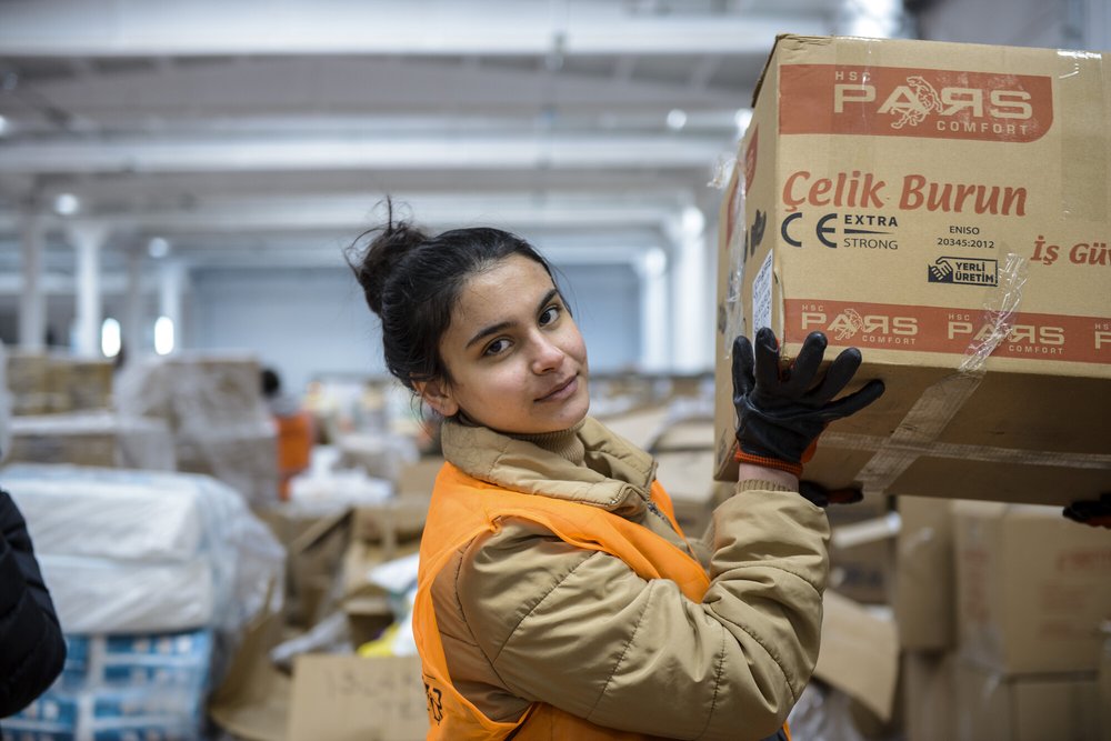 A young women handling boxes of donated items