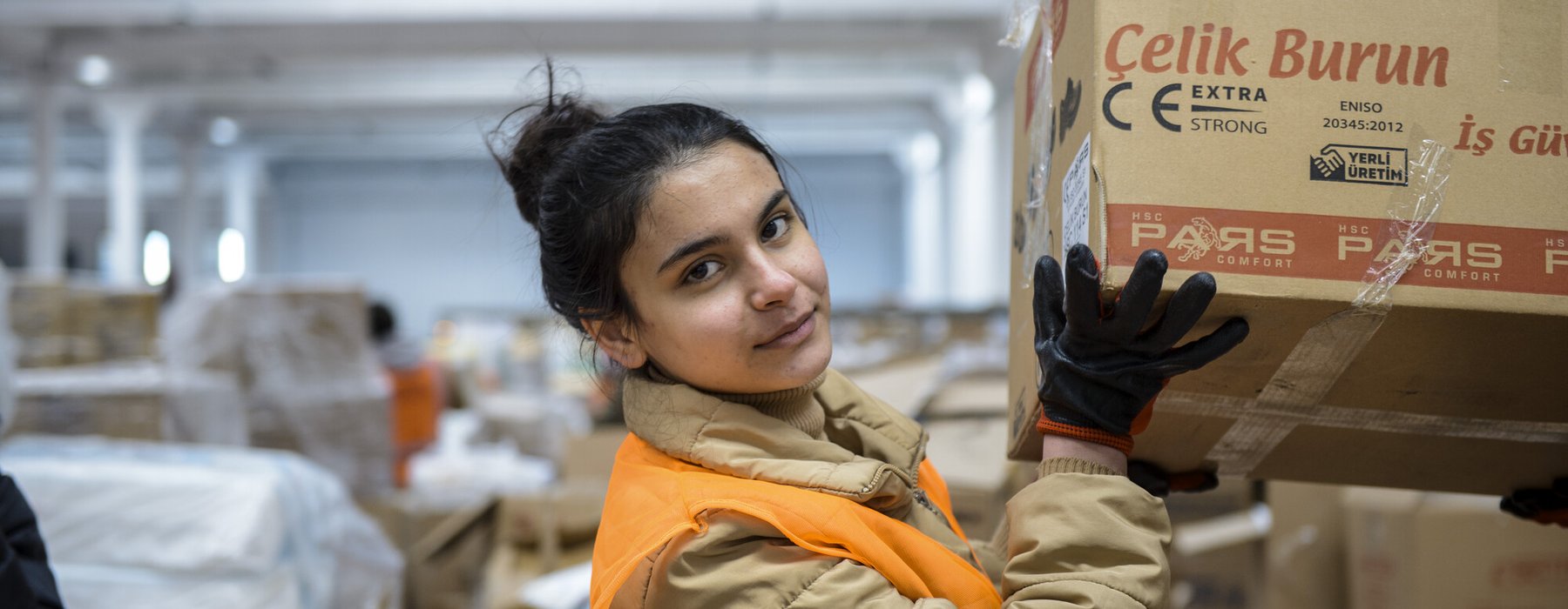 A young women handling boxes of donated items