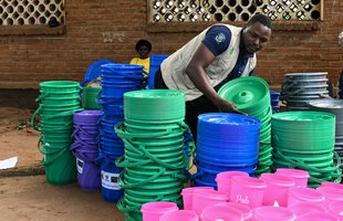 Patience Kayira from Oxfam Malawi arranging relief items meant for Cyclone Freddy survivors, May2023. Photo: Thoko Chikondi / Oxfam