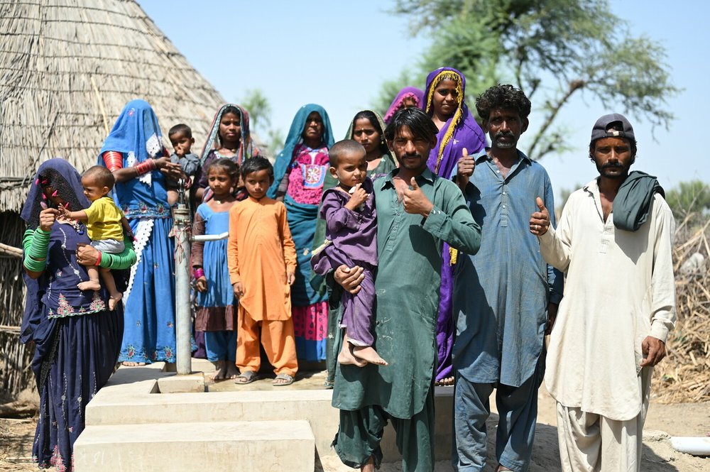 Samjho (far left) with her community and their new hand pump, Sindh province, Pakistan.