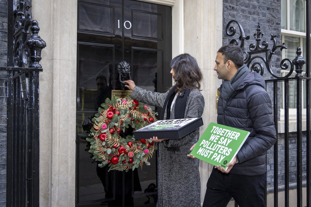Two people approaching the black door of Number 10, Downing Street