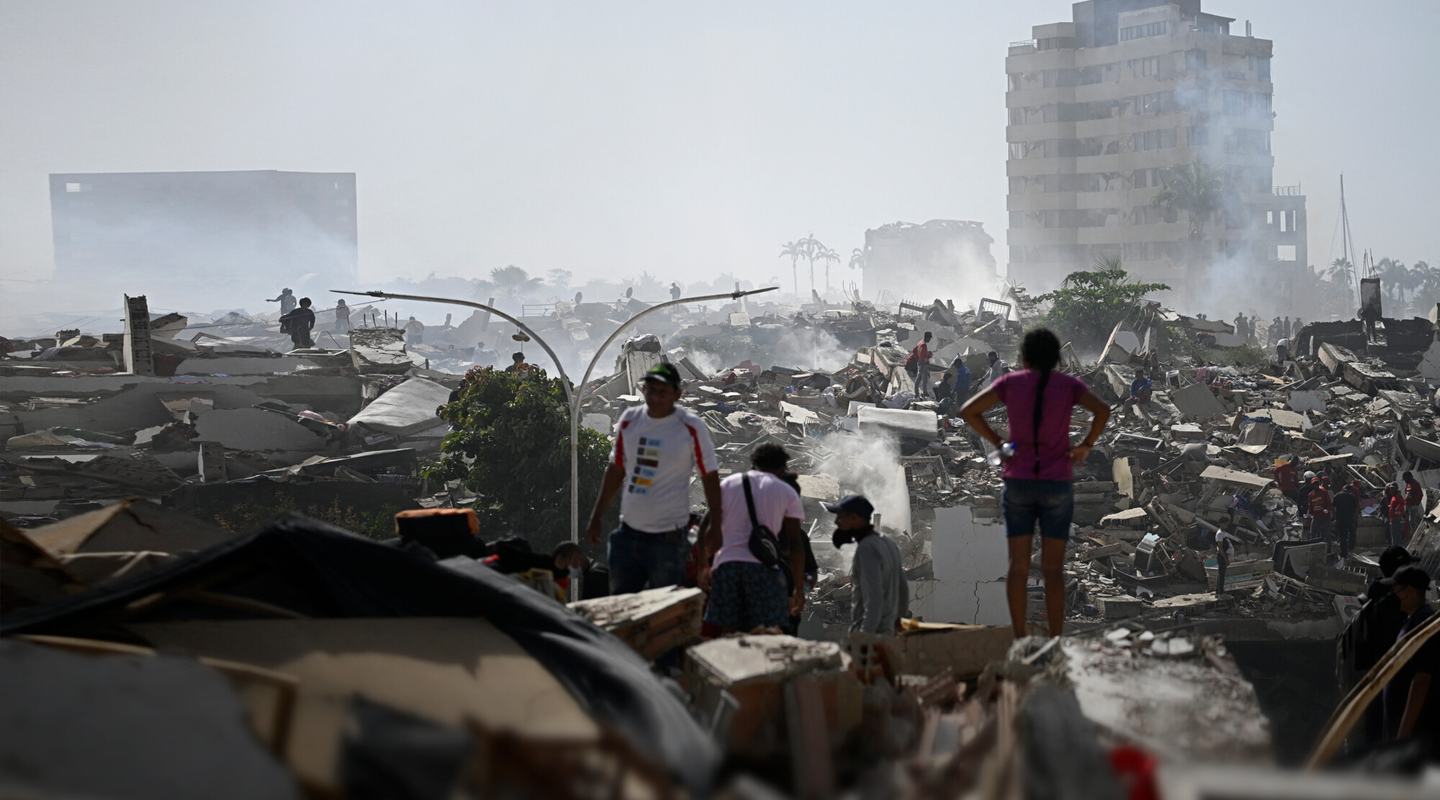 Volunteers search for survivors in a collapsed building following the twin earthquakes in La Guaira state, Venezuela.