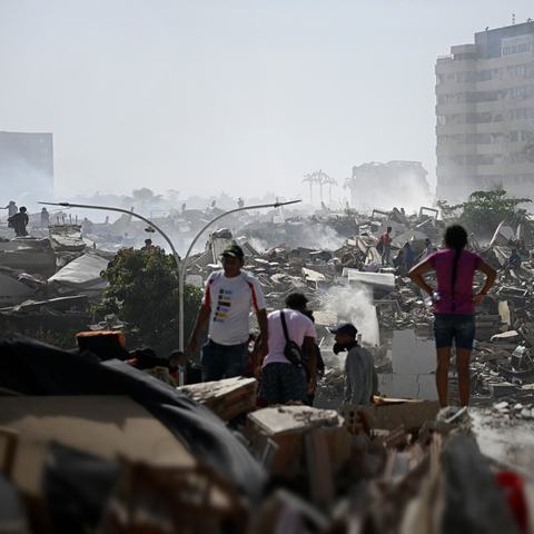 Volunteers search for survivors in a collapsed building following the twin earthquakes in La Guaira state, Venezuela.
