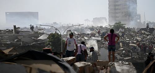Volunteers search for survivors in a collapsed building following the twin earthquakes in La Guaira state, Venezuela.