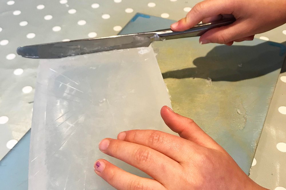 A butter knife and a large block of clear glycerin