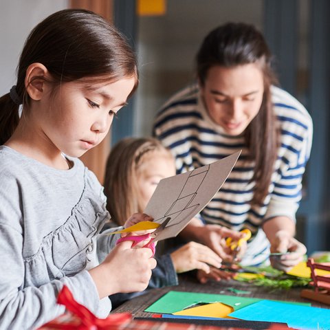 Children cutting decorations for Christmas