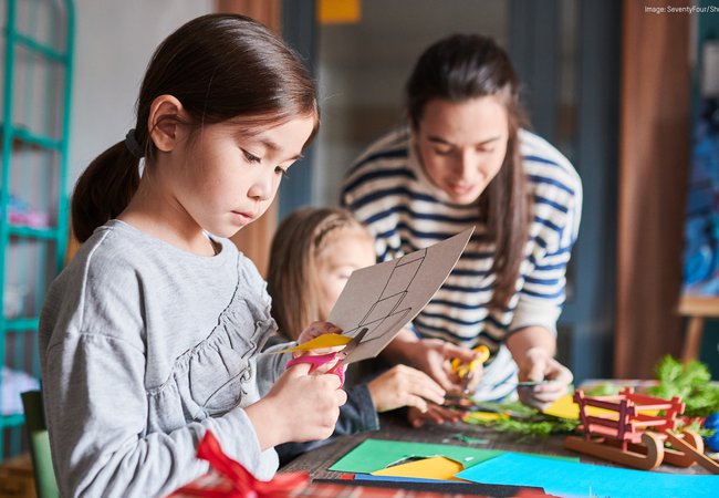 Children cutting decorations for Christmas