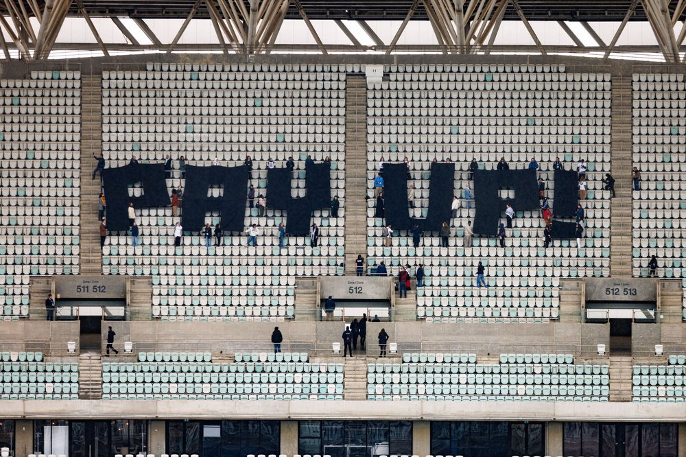 Activists create giant 'Pay Up' message at COP29