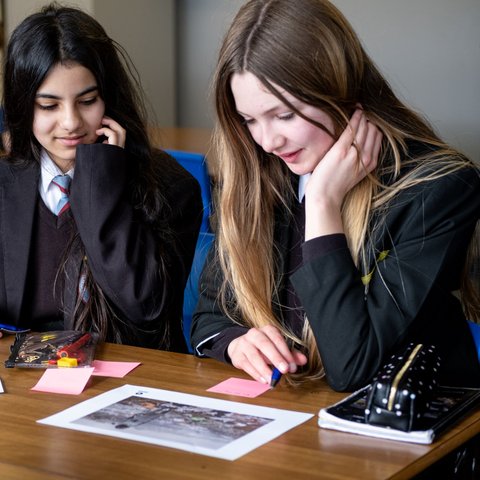 Two young people plan a campaign at a table.