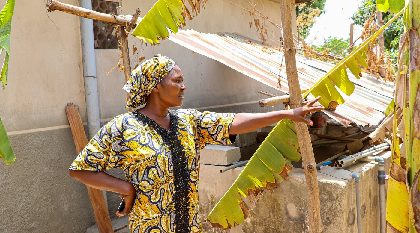 Sarah holding technology and showing her farm in Nasawara state, Nigeria.