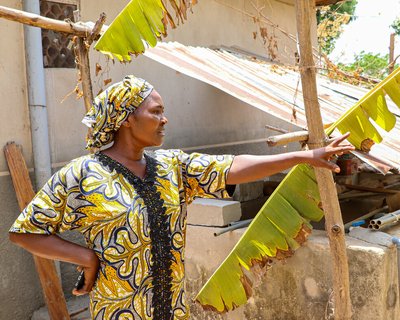 Sarah holding technology and showing her farm in Nasawara state, Nigeria.