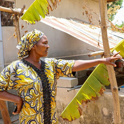 Sarah holding technology and showing her farm in Nasawara state, Nigeria.