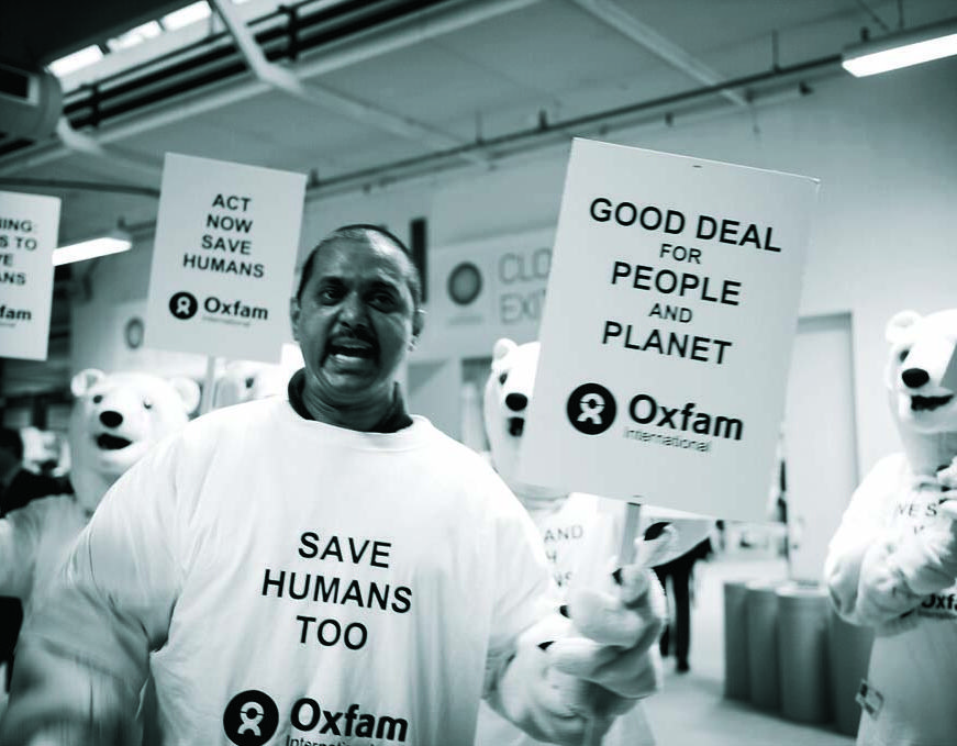 A black and white image of a climate change protestor at a protest