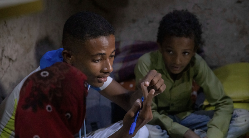 Munadhel counts on his fingers and teaches his siblings