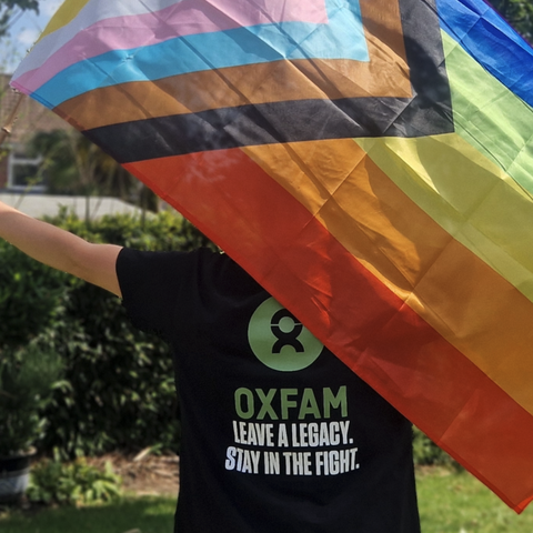 Mx Jones waving pride flag