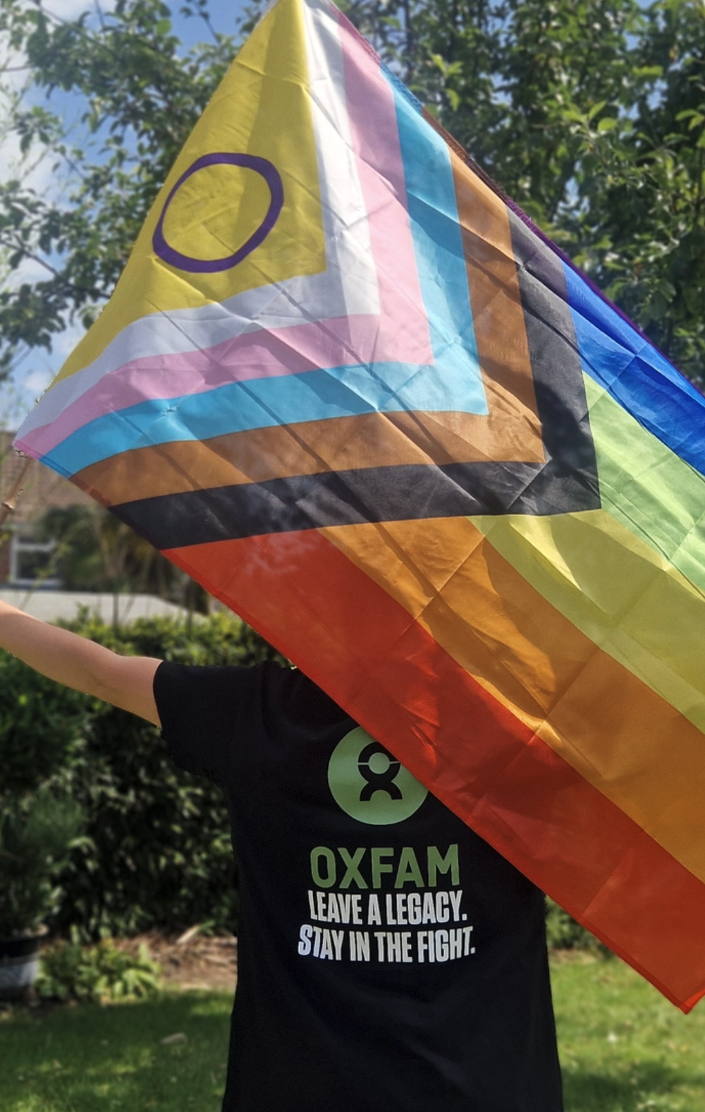 Mx Jones waving pride flag