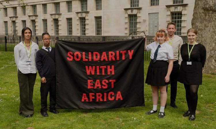 Amario and Mia, Send My Friend to School students, holding 'Solidarity with East Africa' banner alongside Oxfam staff before petition hand in at Number Ten Downing Street.