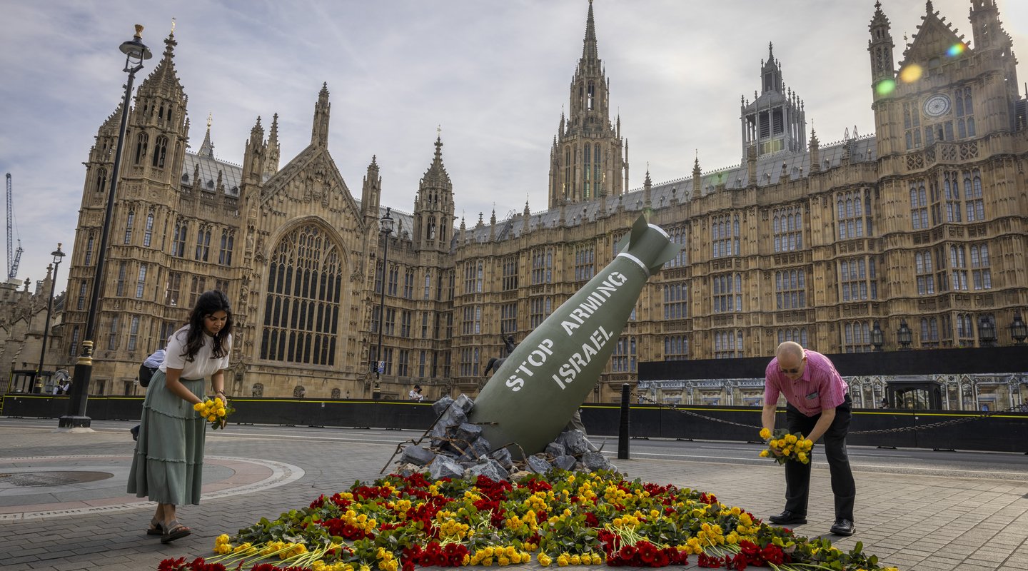 Replica bomb and flowers placed outside UK Parliament