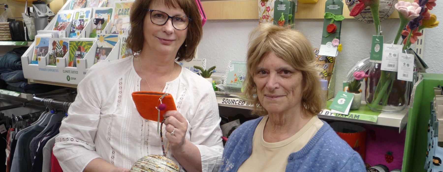 Sylvia and Shop Manager Jan standing together inside an Oxfam shop