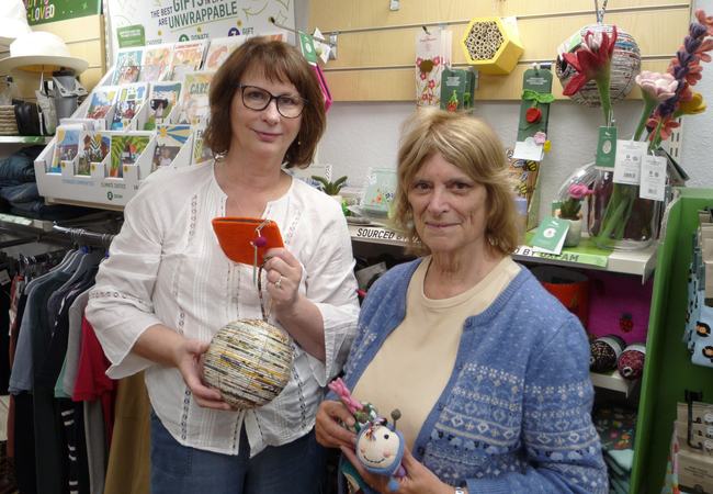 Sylvia and Shop Manager Jan standing together inside an Oxfam shop