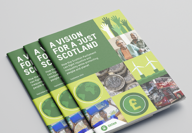 Stack of three Oxfam Scotland reports titled “A Vision for a Just Scotland: How the Scottish Parliament can fight injustice and inequality while protecting people and planet.” The cover design features green and yellow blocks with images including raised