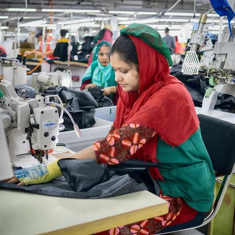 Textile workers are working inside a garment factory in Savar, Bangladesh.
